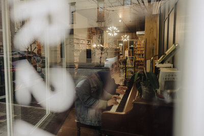 couple playing the piano in a book store in kokomo
