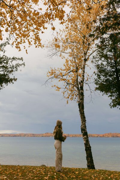 Woman standing looking out at lake