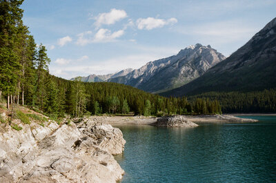 a glacier blue lake framed by mountains in Kananaskis