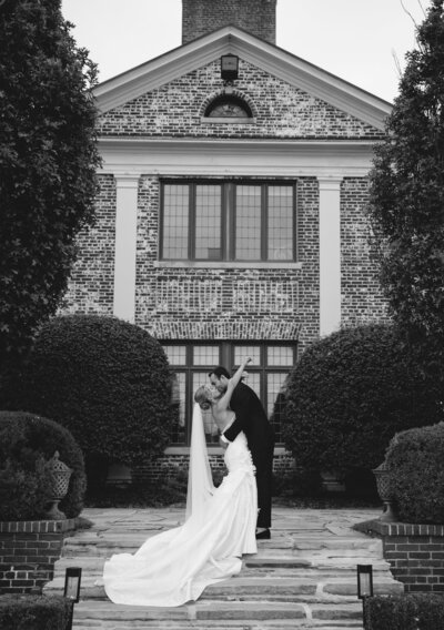 Bride and groom sharing a quiet moment on the steps of the Hamilton Farm Golf Club in New Jersey.