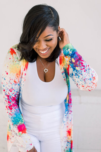 Roni in colorful blouse smiling