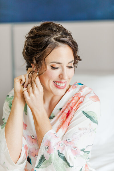 bride putting on earring