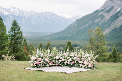Grounded ceremony arch by Flowers By Janie, artful Calgary, Alberta wedding florist, featured on the Brontë Bride Blog.