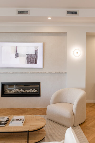 fireplace with white armchair