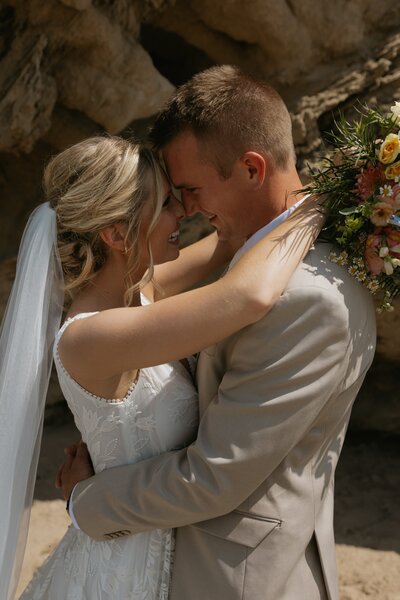 bride and groom hugging