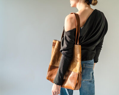 Personal stylist posing with stylish handbag for editorial shoot in Kelowna.