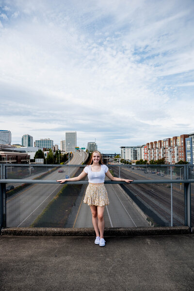 Girl posing on bridge to Glass Museum in downtown Tacoma for high school senior photos