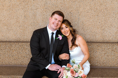 Cute newlyweds smiling at camera after saying their vows at their short elopement at the Parthenon in Nashville