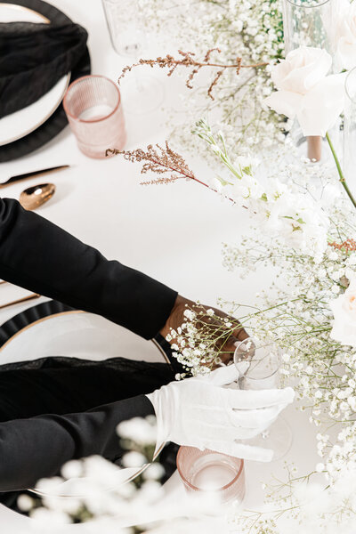 table design with flowers, hands and white glove
