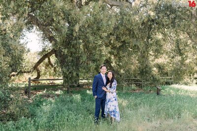 Engaged couple pose for photos while standing in the brush at the Ronald W Caspers Wilderness Park in San Juan Capistrano