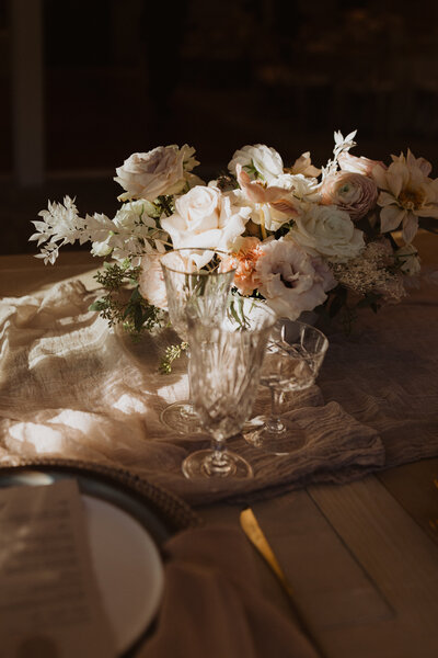White and coral florals on wedding table scape