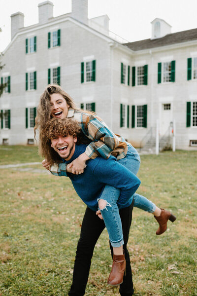 couple piggybacking and playing taken by nashville engagement photographer