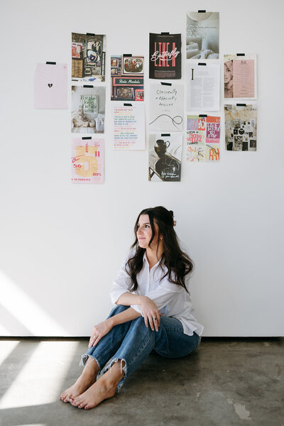 sophie kennedy website designer sitting on floor under brand photo collage