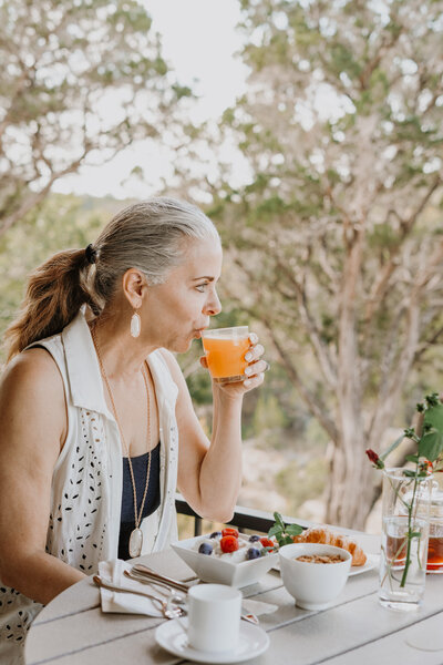 Woman drinking orange drink in a glass