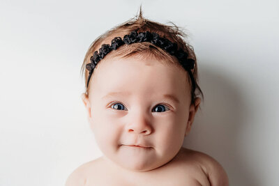 Mom snuggling newborn baby boy in a dreamy lifestyle set in harrisburg newborn photos