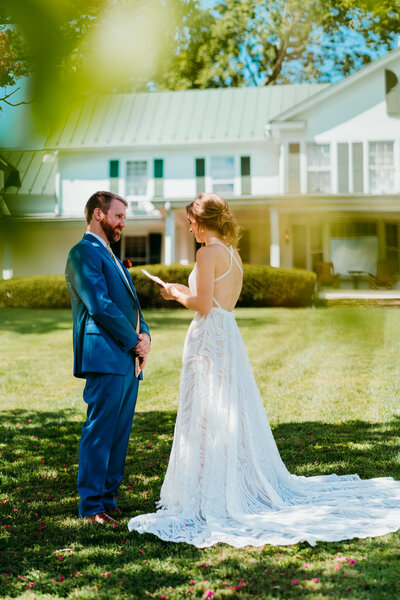 Bride and groom having a joyful first look on the front lawn before Virginia elopement ceremony