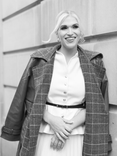 International wedding planner Tori Perano wearing a black dress and black and white earrings.
