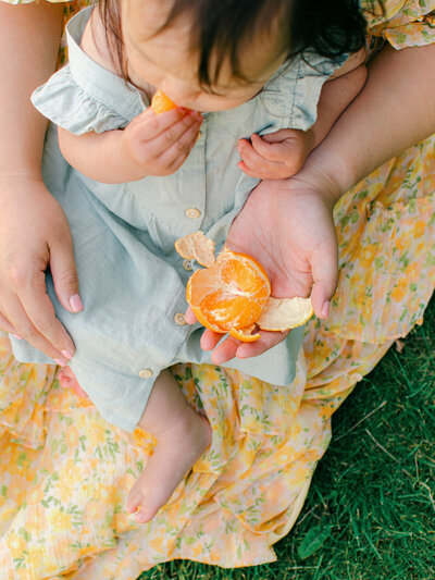 mother and daughter eat oranges together in giethoorn