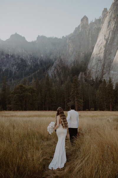 Couple walks together in Yosemite valley