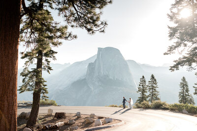 A groom sweetly touches his brides face in front of a beautiful lake view on their mammoth wedding day. 