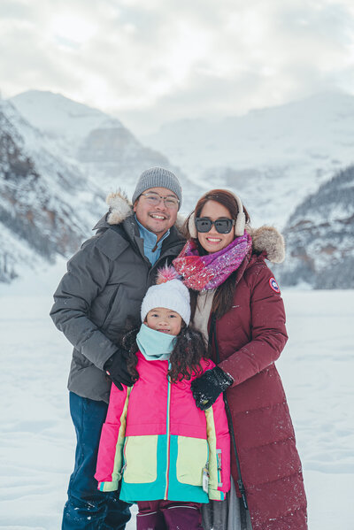 Family of three photo during the winter in lake louise