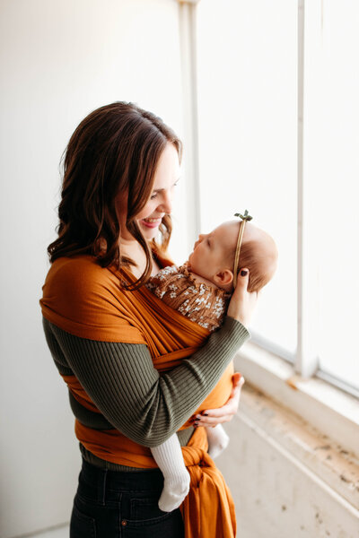 mom holds her baby in south bend indiana studio setting