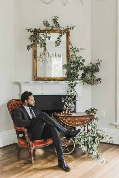 Wedding Photographer & Elopement Photographer, groom sitting next to fireplace