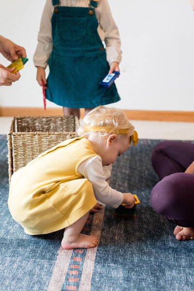 A group of small children playing with toys