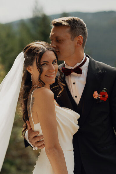 groom kissing his bride  during their wedding at Caleb Pike in Victoria by Latitude 49 Photography
