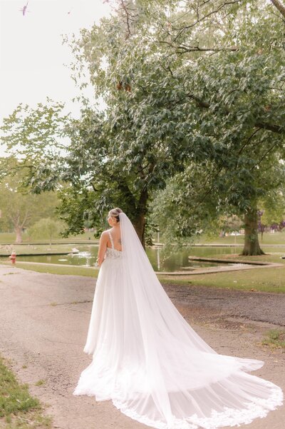 Full length image of bride with veil and dress.