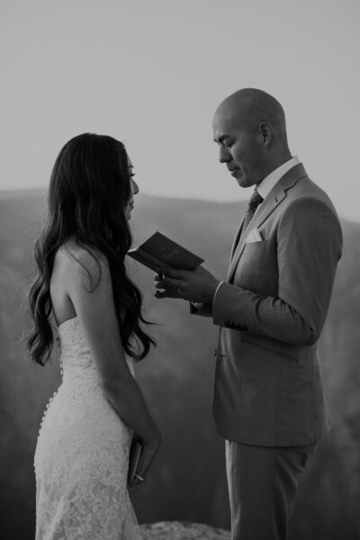 Bride and groom read vows in Yosemite