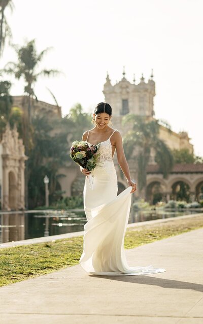 MERMAID WEDDING DRESS WITH BEADED STRAPS A modern take on a classic mermaid silhouette, this incredible wedding dress by designer Stella York is a blinged-out masterpiece! Lace and tulle over regency organza create a very sexy silhouette that hugs at the waist and flares in dramatic fashion just above the knees. Adorned with hundreds of bugle beads and sequins, this dress delivers on style. Beaded straps meet at a plunging sweetheart neckline, which is embellished with organically-finished lace and three unique off-the-shoulder straps that are detachable for a more custom look. Heavy lace placement on the bodice creates an interesting and dramatic pattern that lightens as it floats down the tulle skirt, adding movement. Gorgeously-beaded throughout, this wedding dress ends with a long train and fabric covered buttons in the back.