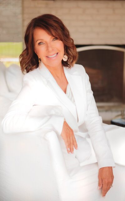 Leisa smiling in a white suit