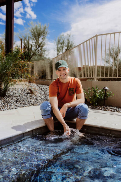 Madison Wetter, Cave Creek real estate agent, sitting poolside at home in Arizona, smiling and relaxed. Learn more about Madison’s story and real estate expertise in Cave Creek, Carefree, and North Scottsdale