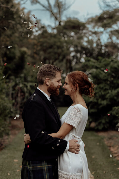 Groom and Bride under confetti, Brisbane Wedding Couple