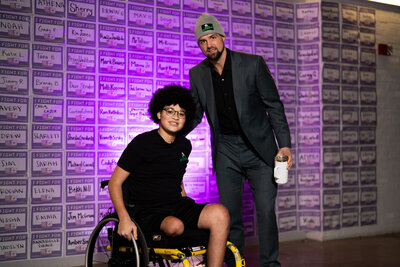 a teenage pediatric cancer warrior posing with a Dallas Stars player