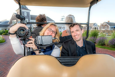 wedding videographers on golf cart holding cameras