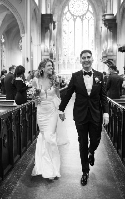 Bride and groom walking down the aisle at Manhattan's Grace Church