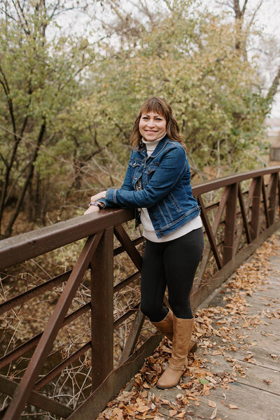 Dr. Richelle leaning on a railing