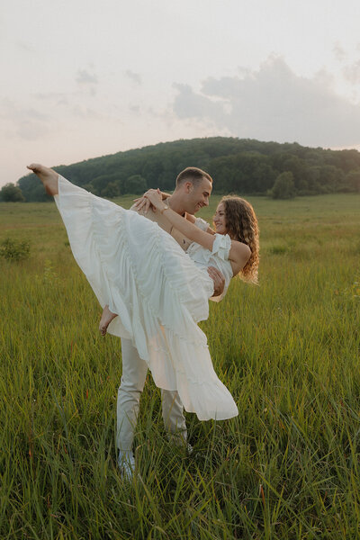 golden hour couples photoshoot in a green grassy field