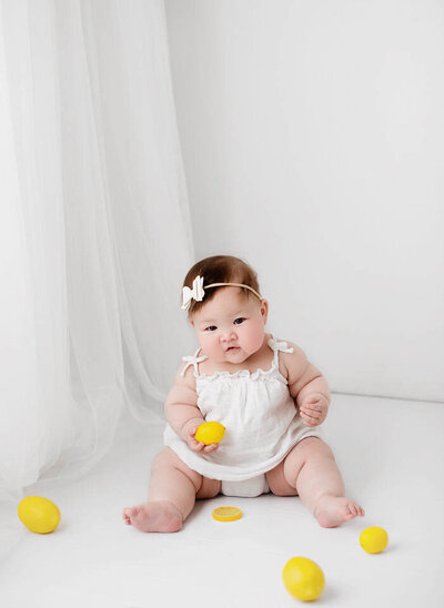 Baby is posed on a blanket during a photoshoot in a vancouver photography studio