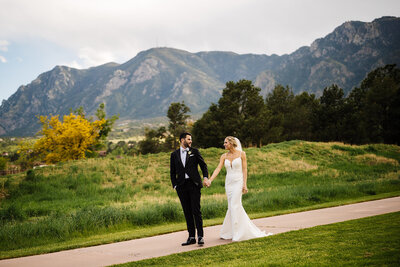 Bride and Group hold hands at Cheyenne Mountain Resort in Colorado Springs, Colorado.