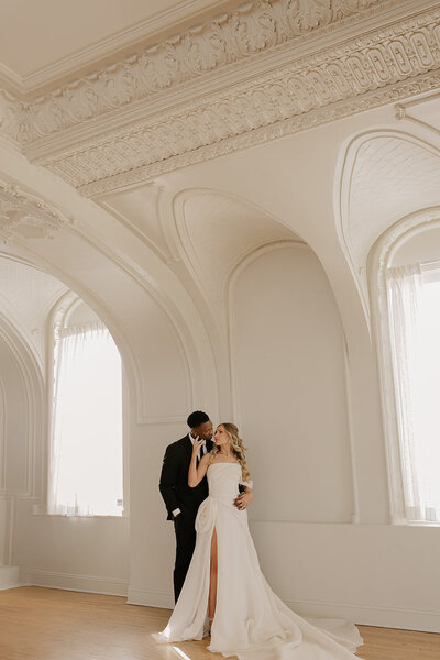 Bride and groom celebrate their elegant luxury wedding at the historic Cottonwood Hotel in Omaha, NE – timeless moments captured by Tori Nichole Photography. A perfect blend of sophistication, romance, and architectural charm, showcasing the couple's love story in an unforgettable setting.