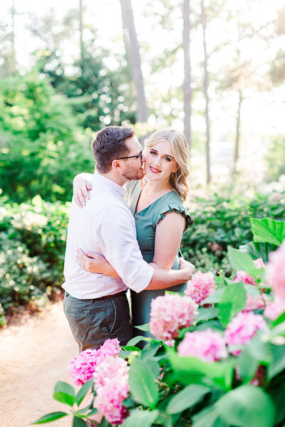 Engagement photos in a garden by Raleigh Wedding Photographer