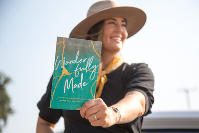 Allie Marie Smith, holding up her book: Wonderfully Made