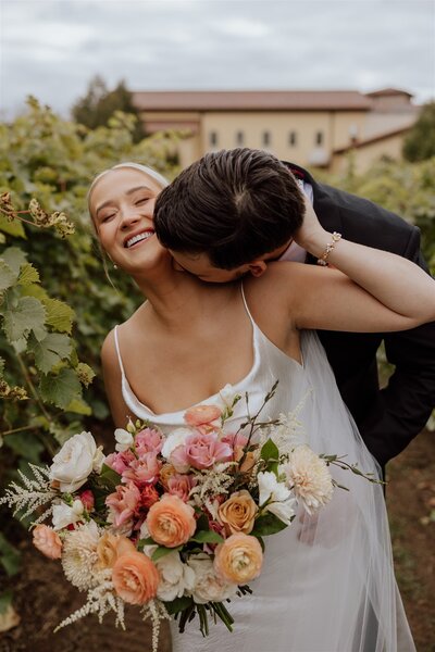 woman fixing brides bouquet of flowers