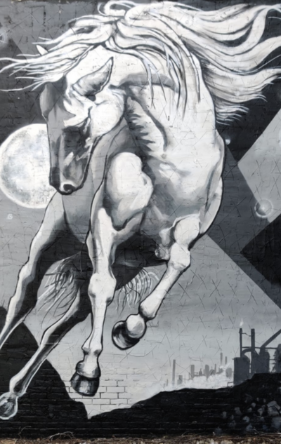 black and white mural of a horse