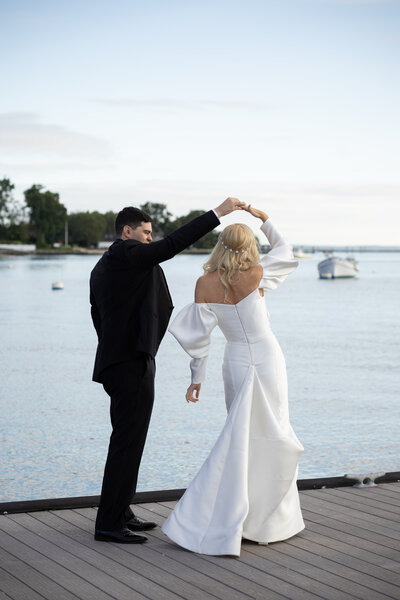 a bride and groom dance on the dock of Stamford Yacht Club