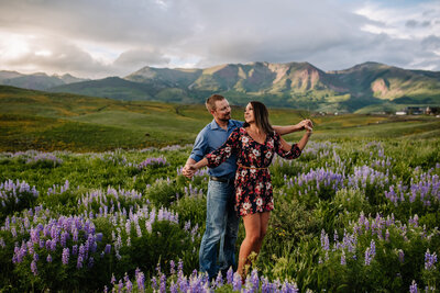 couple embracing in front of mountains