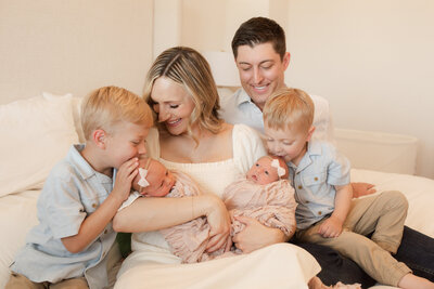 Family of 6 loving on their twin baby girls.